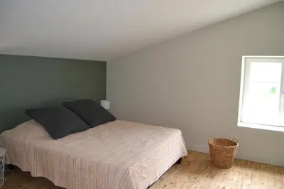 Un ou plusieurs lits dans un hébergement de l'établissement Gîte de la Foye - Le magnolia