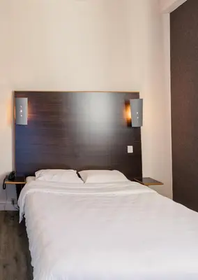 Un ou plusieurs lits dans un hébergement de l'établissement Hôtel de la Vendée