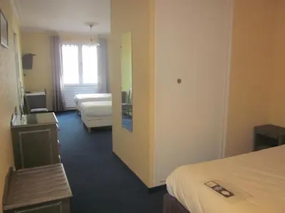 Un ou plusieurs lits dans un hébergement de l'établissement Hotel La Chaumière