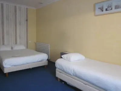 Un ou plusieurs lits dans un hébergement de l'établissement Hotel La Chaumière