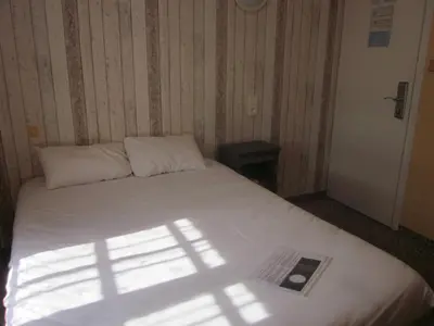 Un ou plusieurs lits dans un hébergement de l'établissement Hotel La Chaumière