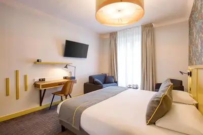 Un ou plusieurs lits dans un hébergement de l'établissement Best Western Hotel Graslin