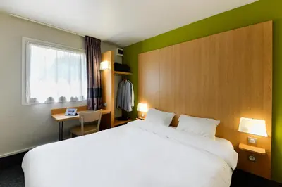 Un ou plusieurs lits dans un hébergement de l'établissement B&B HOTEL Nantes Aéroport