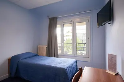 Un ou plusieurs lits dans un hébergement de l'établissement Hotel Le Petit Duquesne