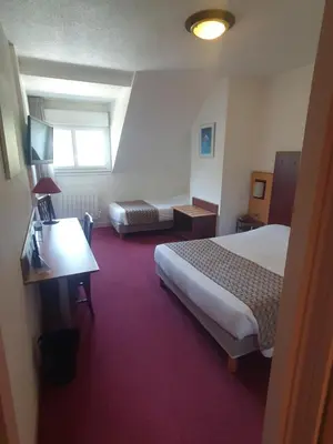 Un ou plusieurs lits dans un hébergement de l'établissement Logis Hotel De La Loire Ancenis - Restaurant Les Bateliers