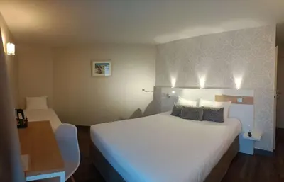 Un ou plusieurs lits dans un hébergement de l'établissement Brit Hotel Les Alizes