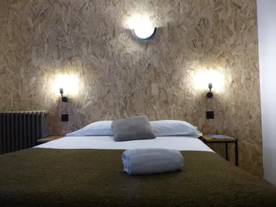 Un ou plusieurs lits dans un hébergement de l'établissement Hotel La Belle Etoile