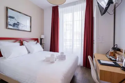 Un ou plusieurs lits dans un hébergement de l'établissement Best Western Hotel De La Plage Saint Marc sur Mer