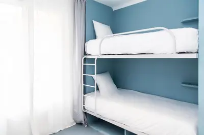 Un ou plusieurs lits dans un hébergement de l'établissement OLDEGAR Hôtel