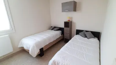 Un ou plusieurs lits dans un hébergement de l'établissement GRAND CAP Appartement 2 chambres vue mer