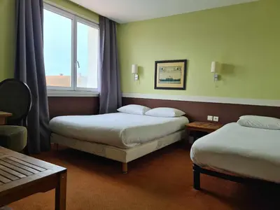 Un ou plusieurs lits dans un hébergement de l'établissement Hotel Cap D'Ambre