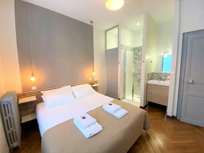 Un ou plusieurs lits dans un hébergement de l'établissement Appartements Rue Sarret XXL