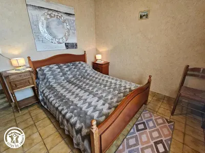 Un ou plusieurs lits dans un hébergement de l'établissement Gîte familial avec jardin privé et barbecue près de La Barre-de-Monts - FR-1-426-104