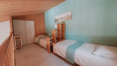 Un ou plusieurs lits dans un hébergement de l'établissement Maison de vacances 300 m de la mer proche forêt