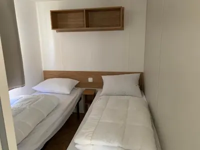 Un ou plusieurs lits dans un hébergement de l'établissement Mobil-home Dan Dom
