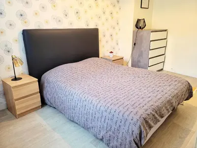 Un ou plusieurs lits dans un hébergement de l'établissement St Jak Appartement
