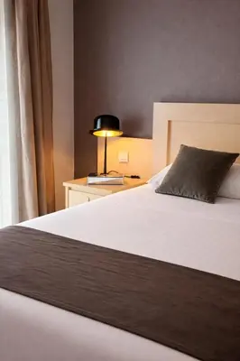 Un ou plusieurs lits dans un hébergement de l'établissement HÔTEL LES PALIS