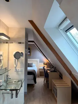 Un ou plusieurs lits dans un hébergement de l'établissement HÔTEL LES PALIS