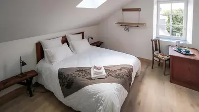 Un ou plusieurs lits dans un hébergement de l'établissement La Houache Chambres d'Hôtes