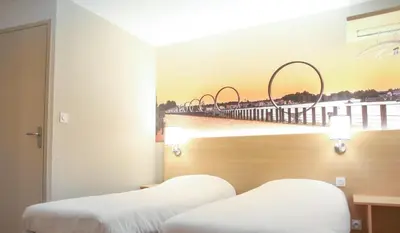 Un ou plusieurs lits dans un hébergement de l'établissement Hôtel Inn Design & Restaurant Châteaubriant