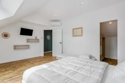 Un ou plusieurs lits dans un hébergement de l'établissement Magnifique villa pour grande famille à La Barre-de-Monts