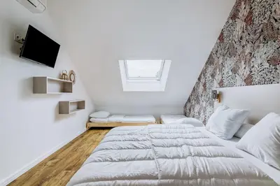 Un ou plusieurs lits dans un hébergement de l'établissement Magnifique villa pour grande famille à La Barre-de-Monts