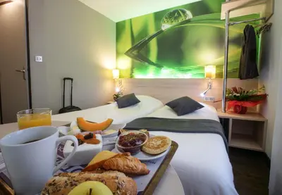 Un ou plusieurs lits dans un hébergement de l'établissement Hôtel Inn Design & Restaurant Challans