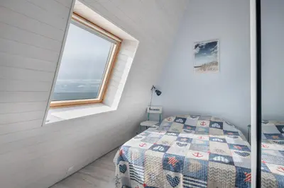 Un ou plusieurs lits dans un hébergement de l'établissement Face à la mer, appartement sous les toits pour 4