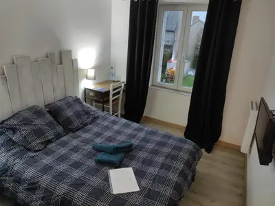 Un ou plusieurs lits dans un hébergement de l'établissement Agréable chambre d'hôte climatisée