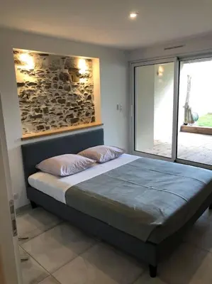 Un ou plusieurs lits dans un hébergement de l'établissement Les Palmiers. Charme, spa et massage en vignoble nantais