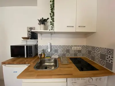 Cuisine ou kitchenette dans l'établissement Le Terracotta - Confort en plein centre