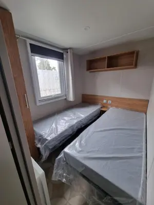Un ou plusieurs lits dans un hébergement de l'établissement Très jolie Mobil home 3 chambres 418