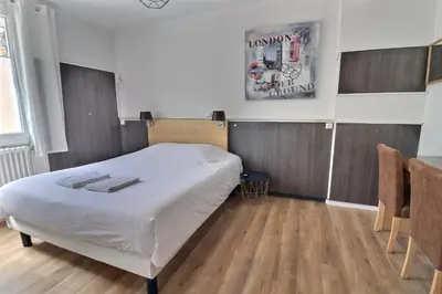 Un ou plusieurs lits dans un hébergement de l'établissement Hôtel Le Smile